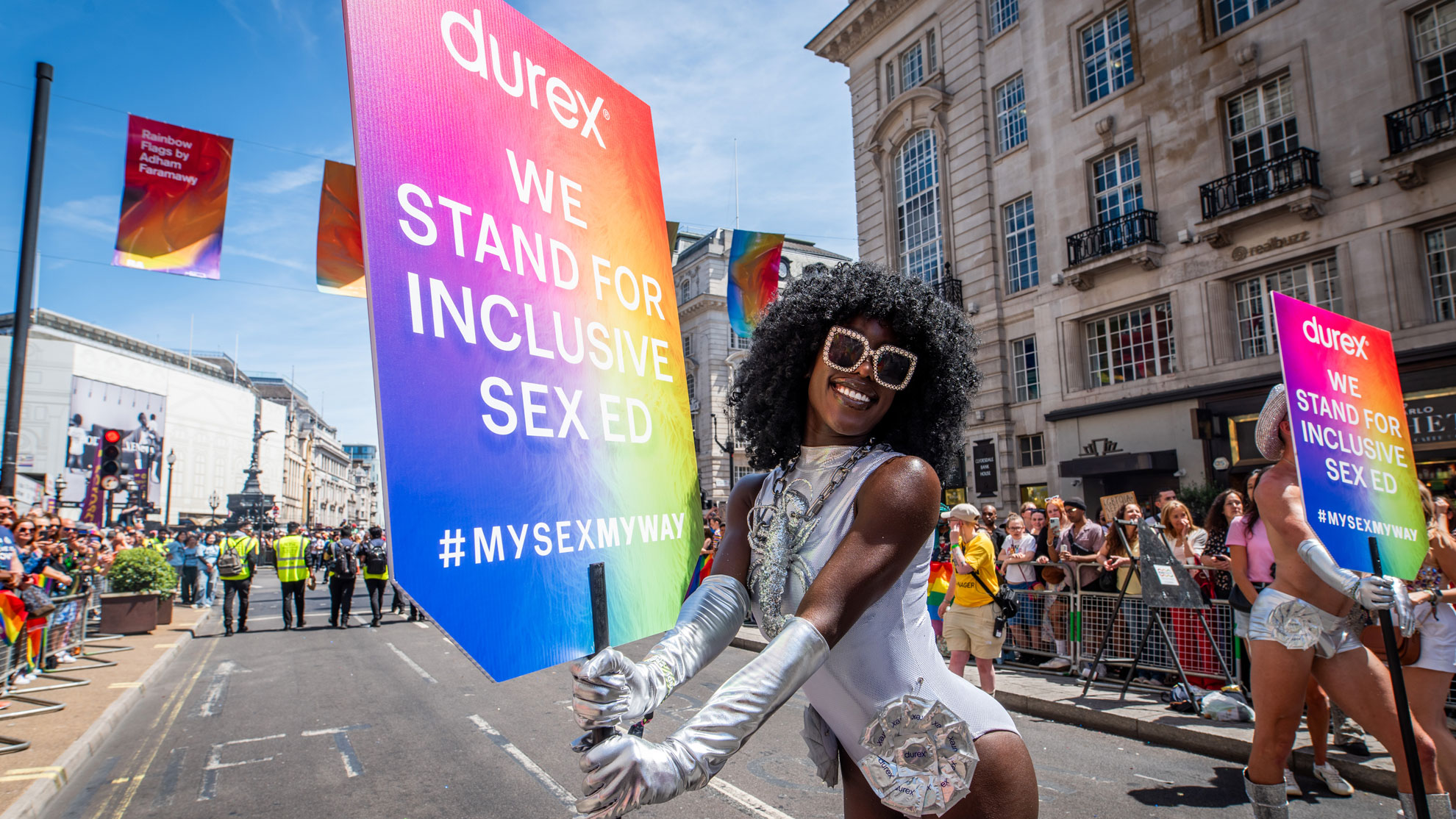 Parade performer at London Pride 2024 with a Durex sign
