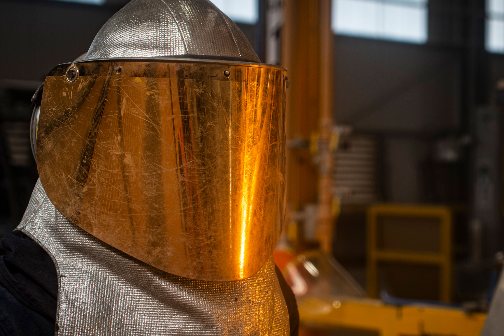 Close up of a golden protective mask in a metal factory